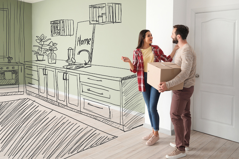 Happy couple imagining interior of new house on moving day