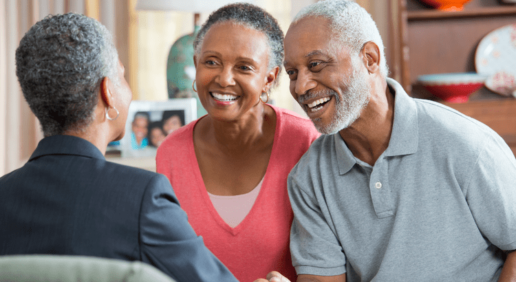 Older couple with real estate agent discussing home equity